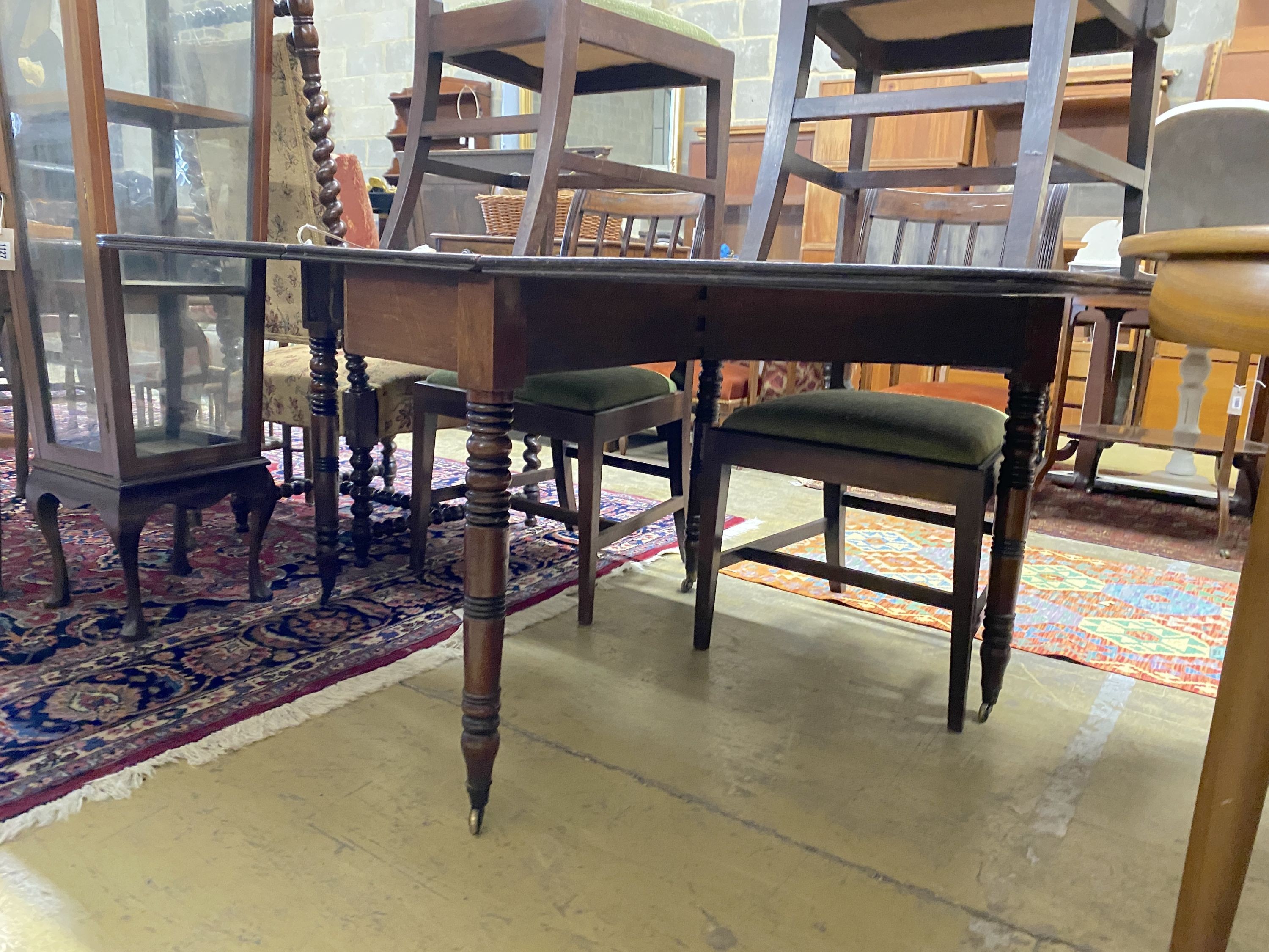 A Regency mahogany drop leaf dining table, 146cm extended, depth 106cm, height 70cm and six Regency provincial mahogany dining chairs, one with arms